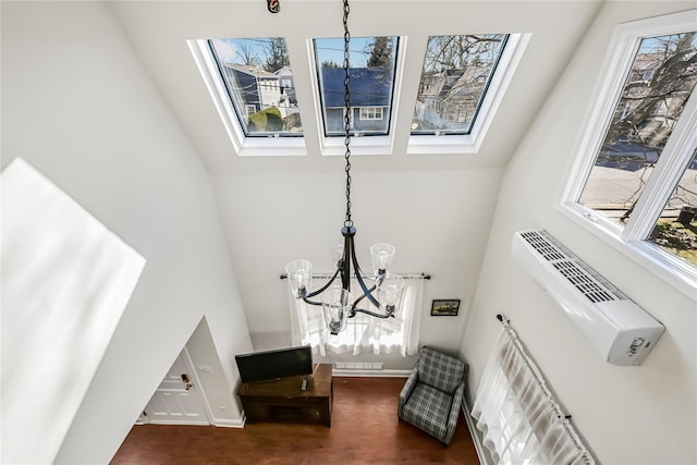 interior space featuring a wall unit AC and an inviting chandelier