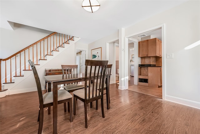 dining room with dark hardwood / wood-style flooring