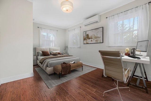 bedroom featuring dark hardwood / wood-style flooring and a wall mounted air conditioner