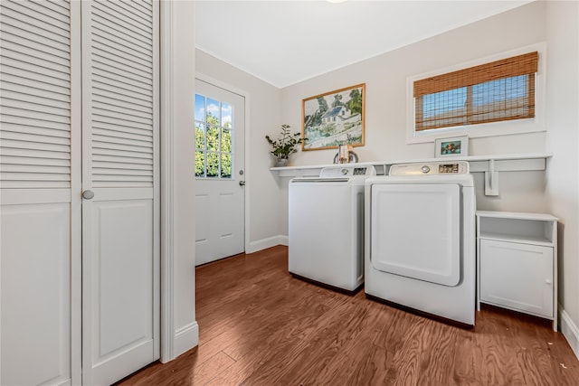 clothes washing area with washer and dryer and wood-type flooring