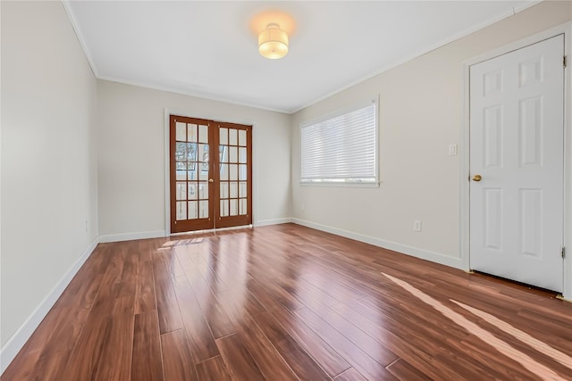 empty room with french doors, dark wood-type flooring, and ornamental molding