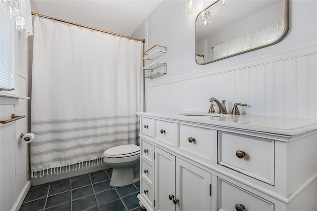 bathroom featuring toilet, vanity, and tile patterned flooring