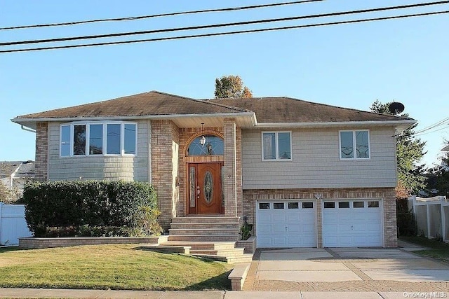 split foyer home with a garage and a front yard