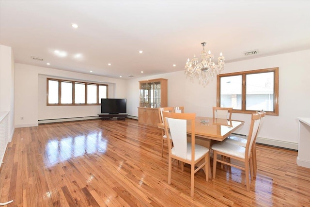 unfurnished dining area with a baseboard radiator, an inviting chandelier, and light hardwood / wood-style flooring