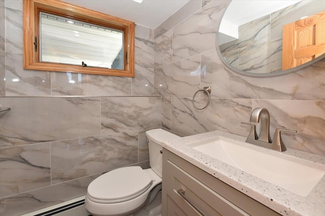 bathroom featuring vanity, a baseboard heating unit, and toilet