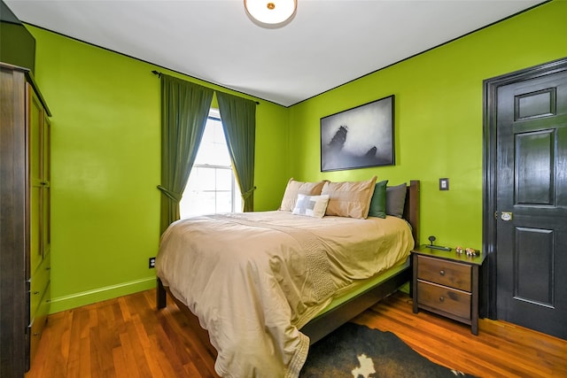 bedroom with dark wood-type flooring