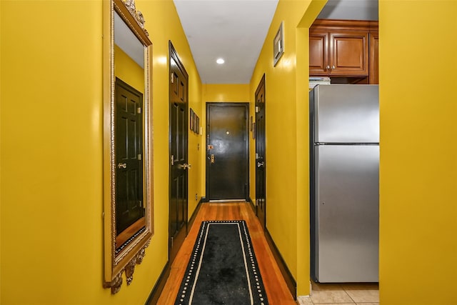 corridor with light tile patterned flooring