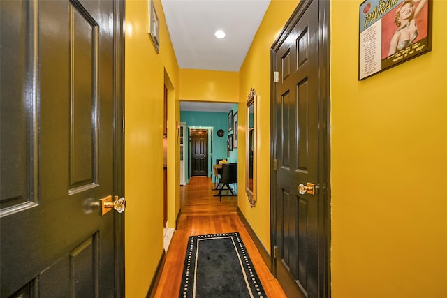 hall with hardwood / wood-style floors