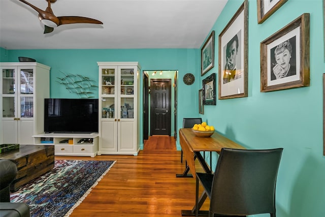 living room featuring ceiling fan and hardwood / wood-style floors