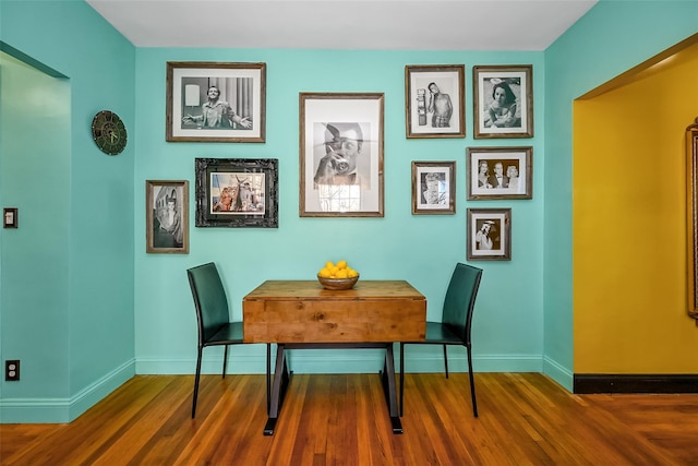 dining room with dark hardwood / wood-style flooring