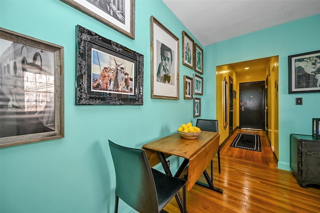 dining space with hardwood / wood-style floors