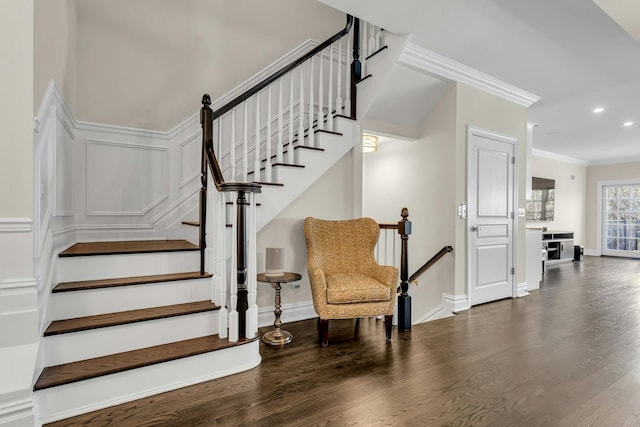 staircase featuring hardwood / wood-style flooring and ornamental molding