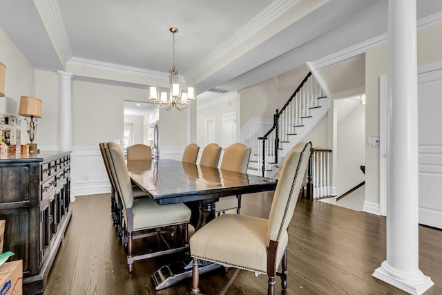 dining space featuring a chandelier, dark hardwood / wood-style flooring, decorative columns, and ornamental molding