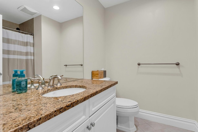 bathroom featuring tile patterned floors, vanity, and toilet