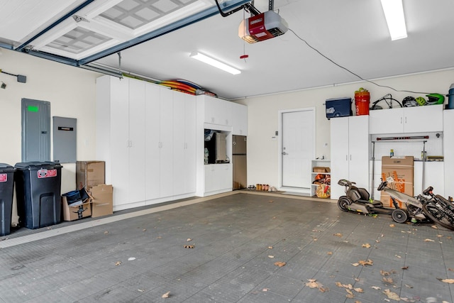 garage with electric panel, stainless steel refrigerator, and a garage door opener