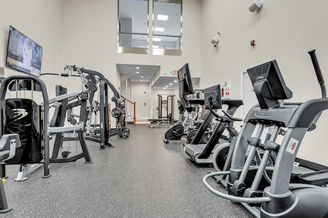 workout area with a high ceiling