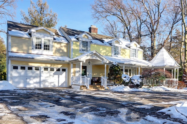 cape cod home with a porch and a garage