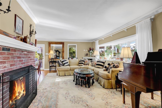 living room with hardwood / wood-style flooring, crown molding, and a brick fireplace