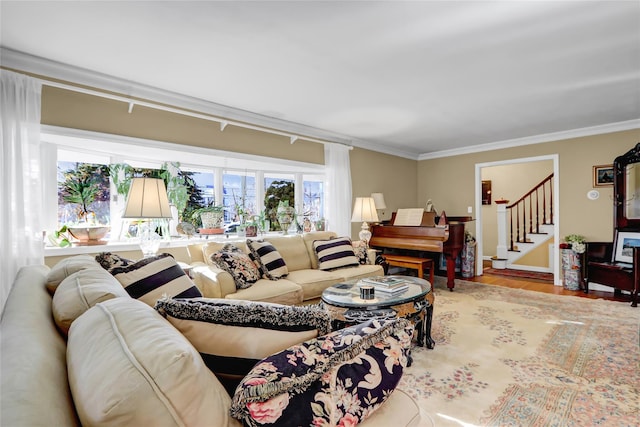 living room with ornamental molding and light wood-type flooring