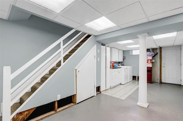 basement featuring a drop ceiling and washer and clothes dryer