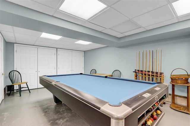 playroom with concrete flooring, a drop ceiling, and billiards