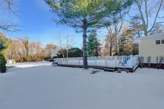 yard covered in snow featuring a wooden deck