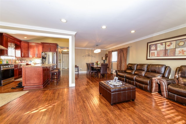 living room with dark hardwood / wood-style flooring and ornamental molding