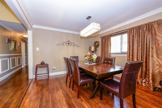 dining space featuring ornamental molding and dark hardwood / wood-style floors