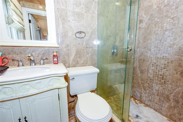 bathroom featuring toilet, vanity, tile walls, and walk in shower