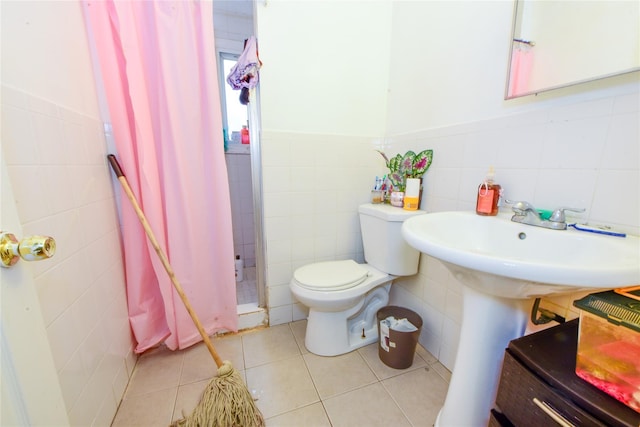 bathroom with tile patterned floors, tile walls, and toilet