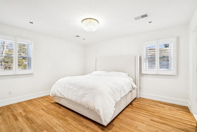 bedroom featuring hardwood / wood-style flooring and multiple windows