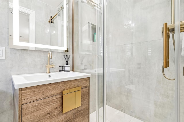 bathroom with vanity and a shower with shower door