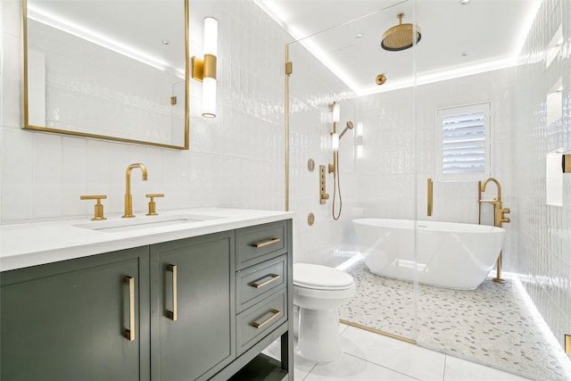 full bathroom featuring tile patterned flooring, vanity, tile walls, and plus walk in shower