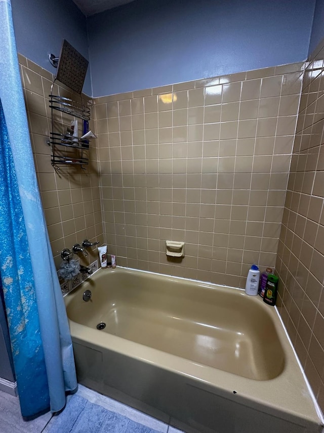 bathroom featuring tile patterned flooring and shower / tub combination