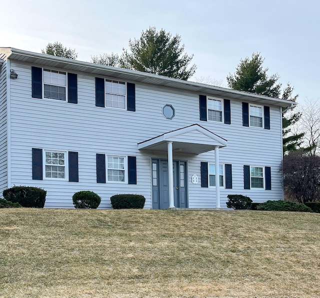 colonial home with a front yard