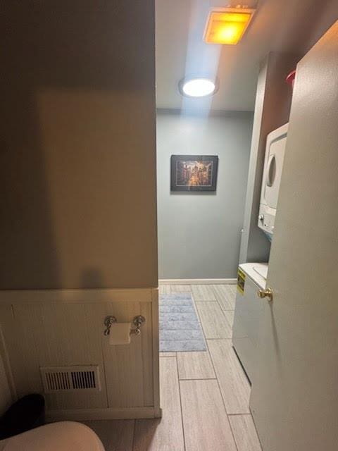 bathroom with stacked washer and clothes dryer