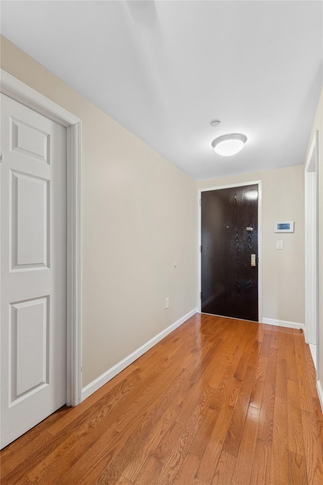 corridor with light hardwood / wood-style floors