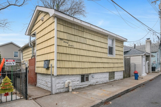 view of home's exterior featuring fence