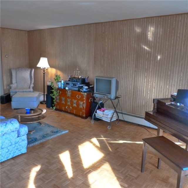 sitting room featuring a baseboard heating unit and parquet flooring