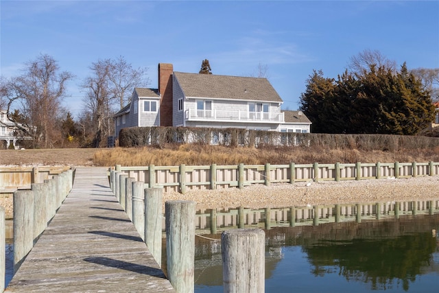 back of house featuring a water view