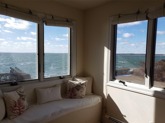 interior space with a baseboard heating unit and a water view