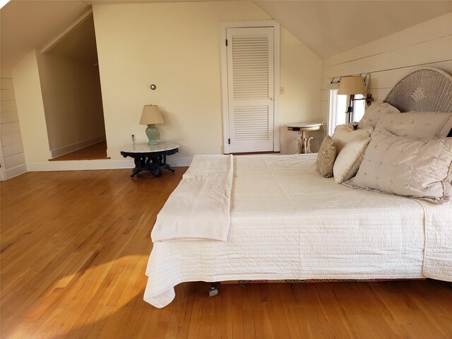 bedroom featuring wood-type flooring and lofted ceiling