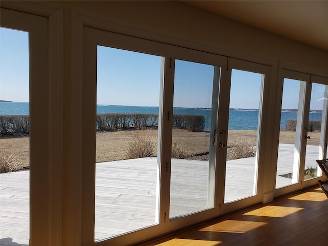 doorway featuring a water view and wood finished floors