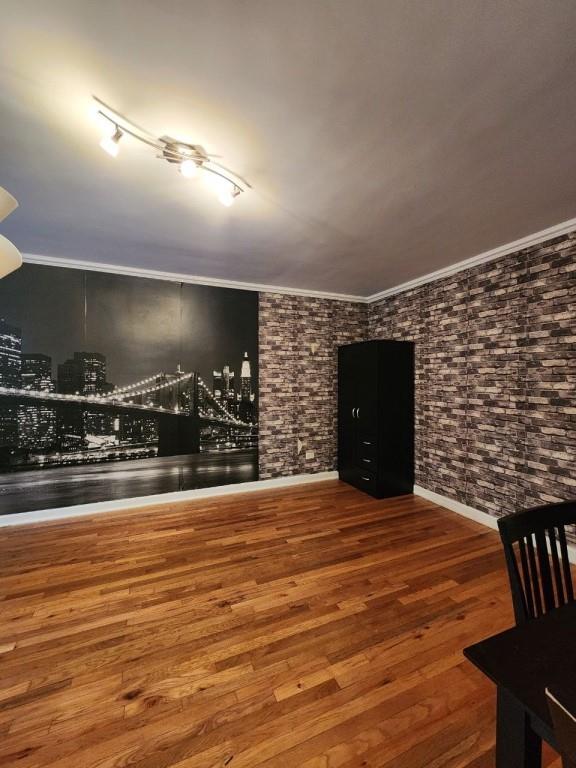 interior space featuring hardwood / wood-style floors and ornamental molding