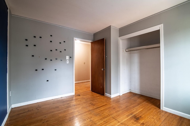 unfurnished bedroom featuring a closet and light wood-type flooring