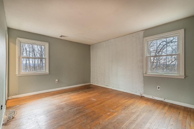 empty room with light hardwood / wood-style floors