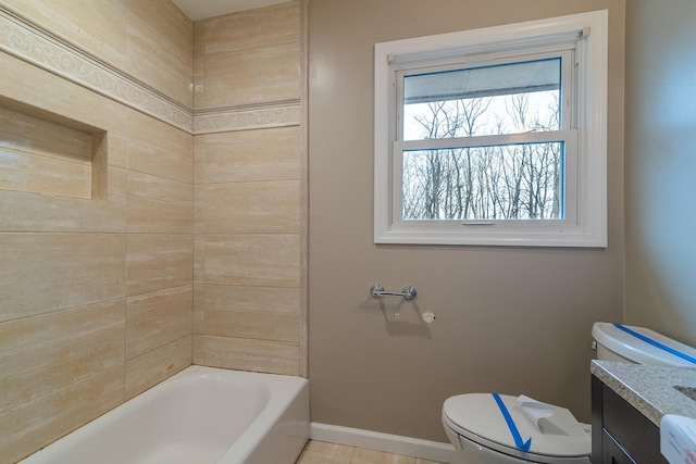 bathroom featuring vanity, a tub, and toilet