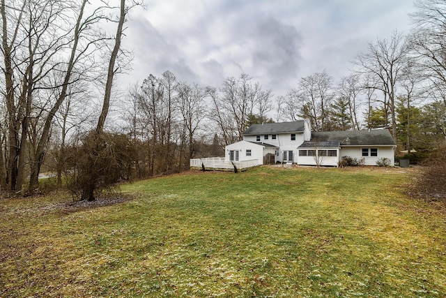 view of yard featuring a wooden deck and a sunroom