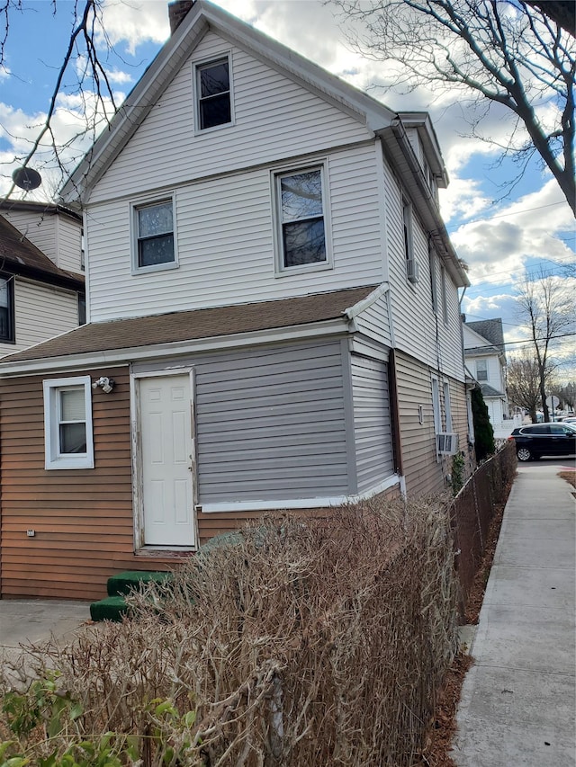 rear view of property with cooling unit