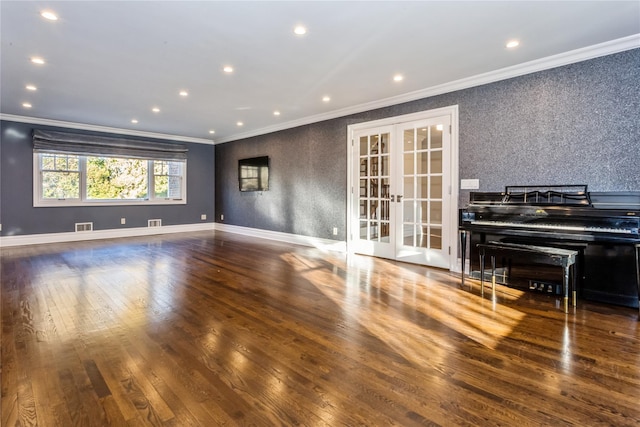 empty room featuring dark hardwood / wood-style floors, crown molding, and french doors